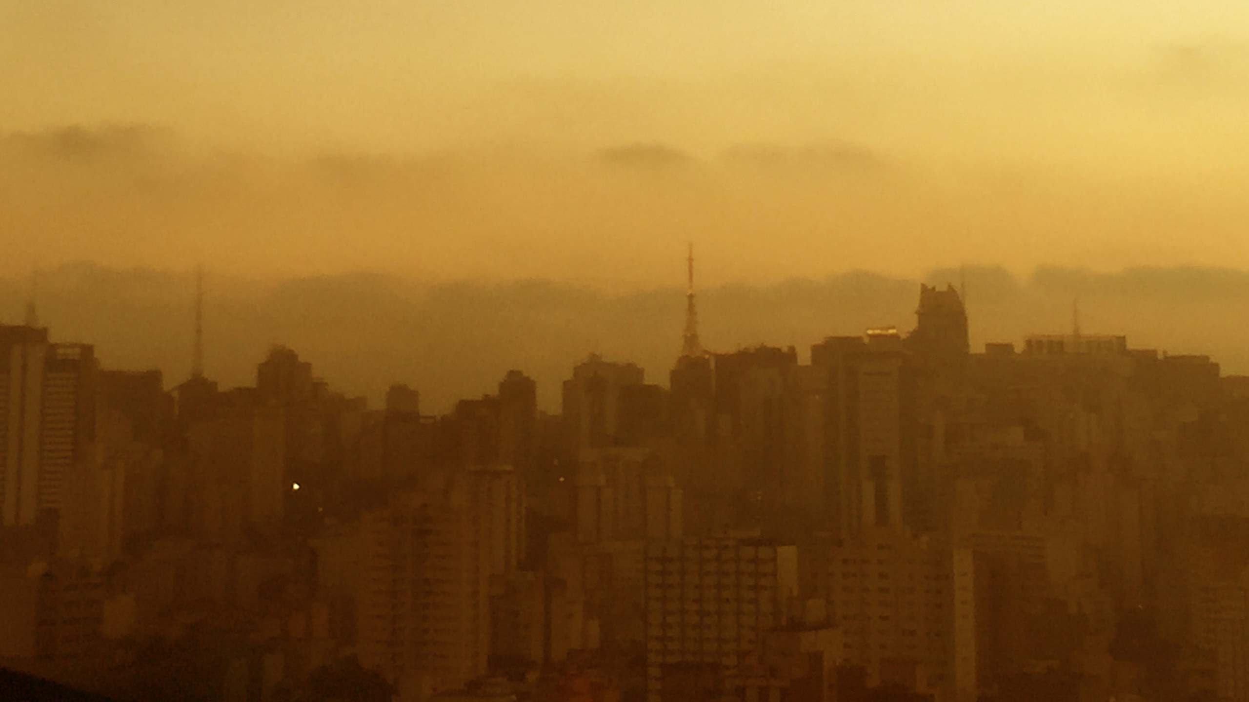 Photograph of a city skyline captured at dusk. 