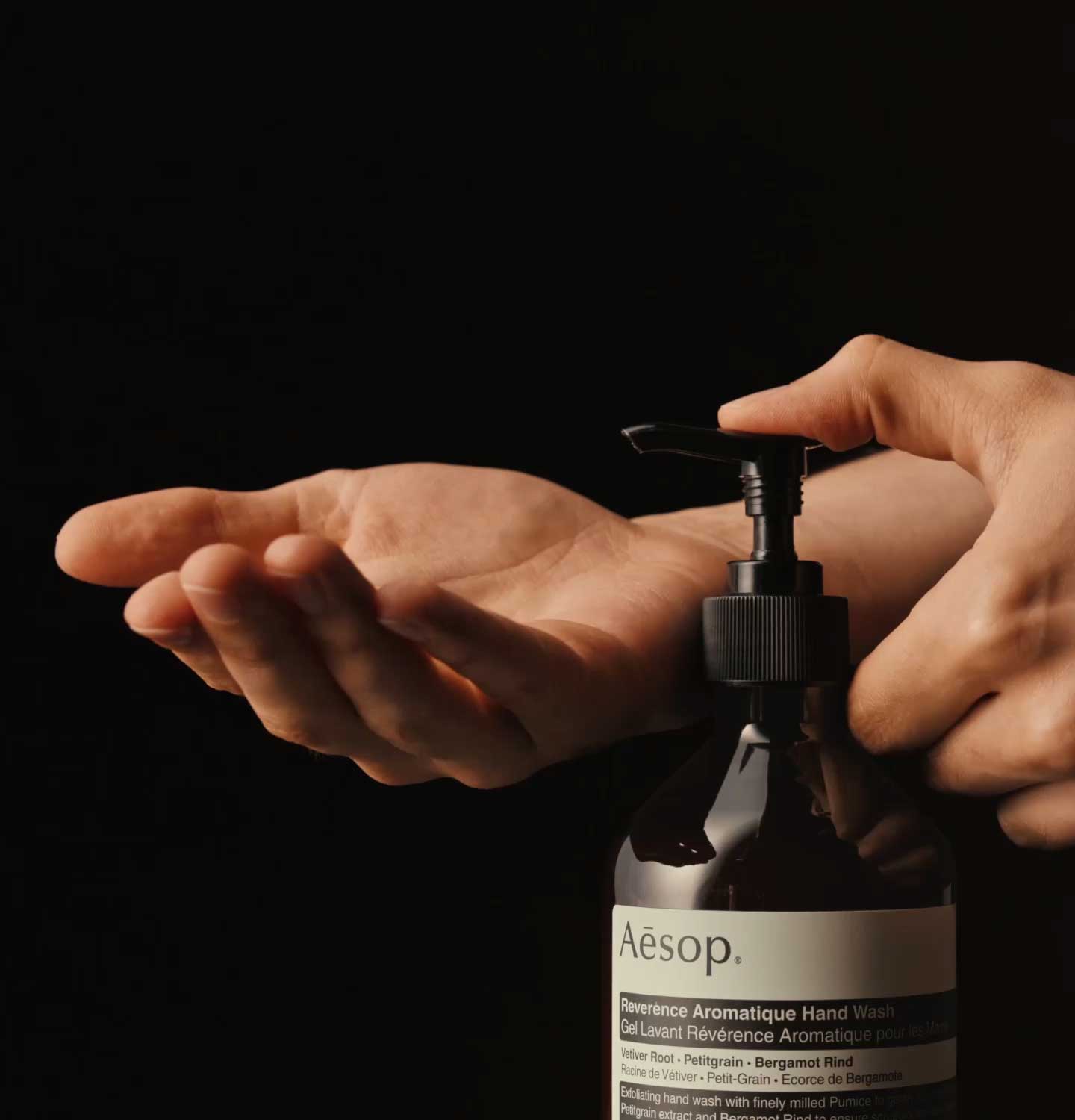 Hands dispensing reverence aromatique hand wash