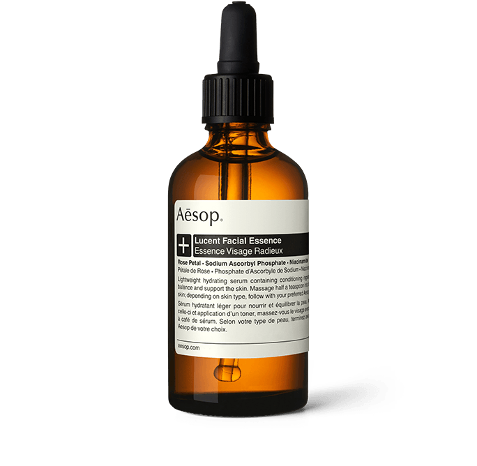 Lucent Facial Essence in an amber glass bottle with a pipette.
