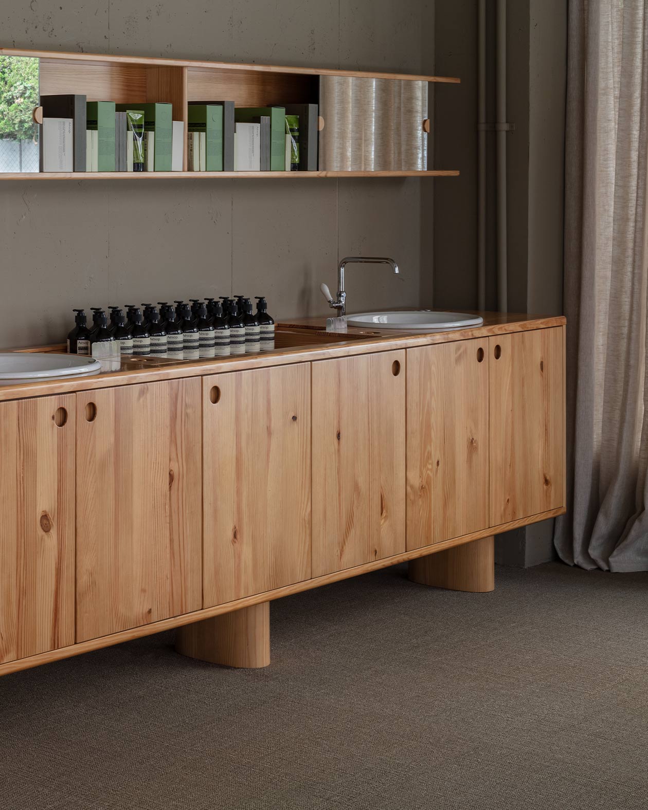 Pine wood furniture, shelves, tables and cabinets with a sink on it