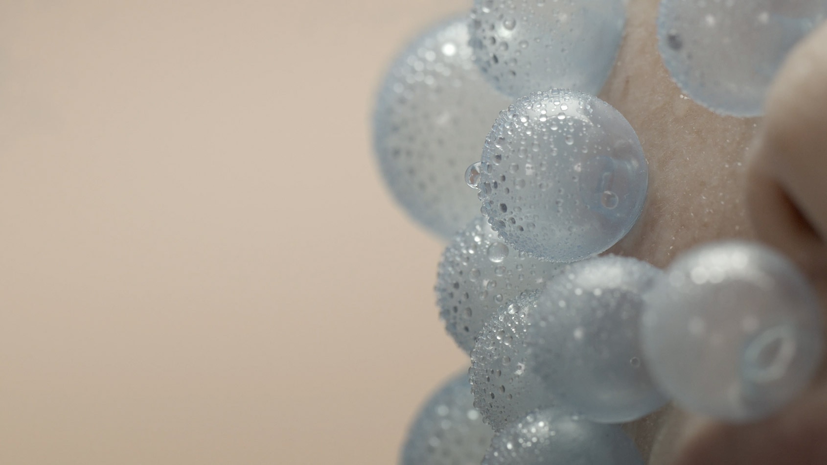 Small blue balloons floating around a face