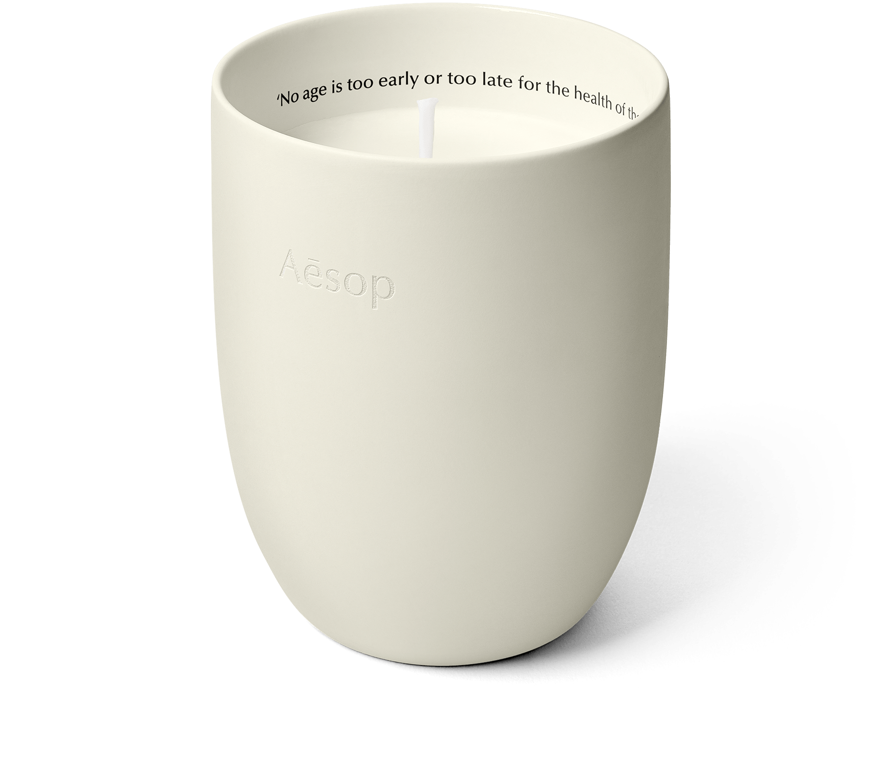 Poured candle in a white ceramic vessel.